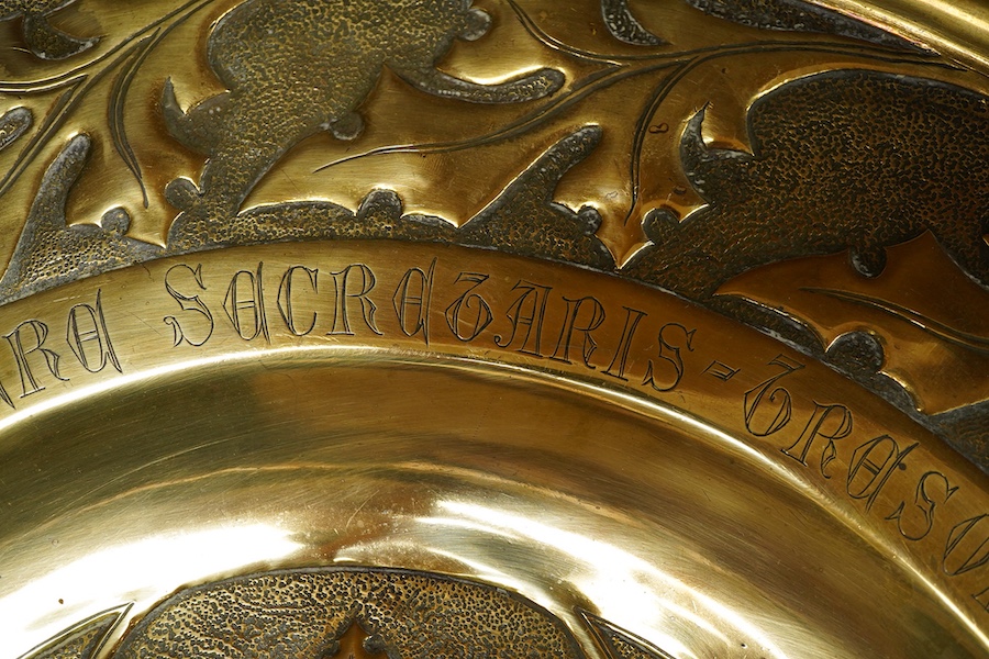 An embossed brass arts and crafts alms charger with inscriptions, 51cm in diameter